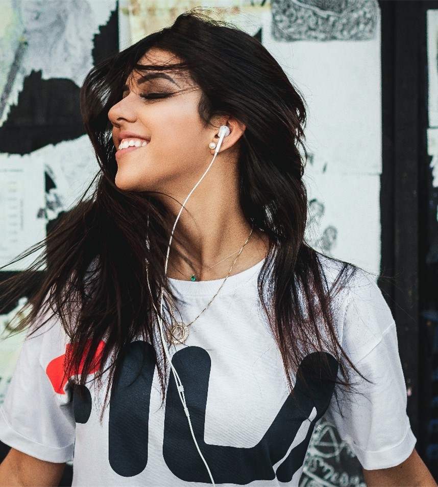 Woman with earbuds Woman listening to music on earbuds