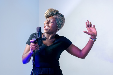 Woman singing into a microphone